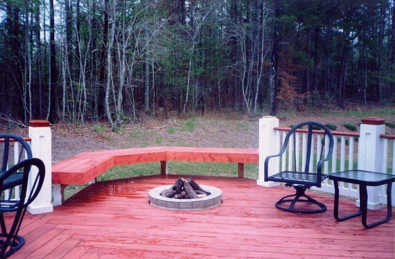 A red deck installed with a small fire pit in Atlanta