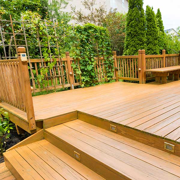Spacious wooden deck overlooking a garden area, built by Decks & More in Atlanta, GA